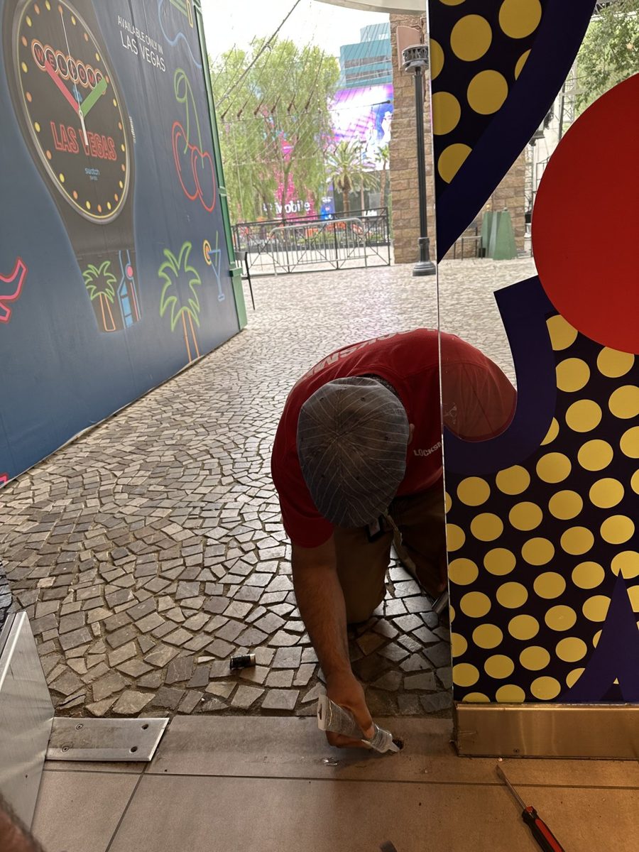 Technician setting a floor lock at a glass storefront door